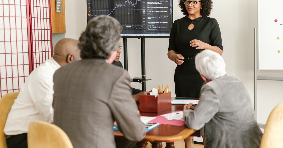 A diverse group of professionals in a modern office discussing business strategies.